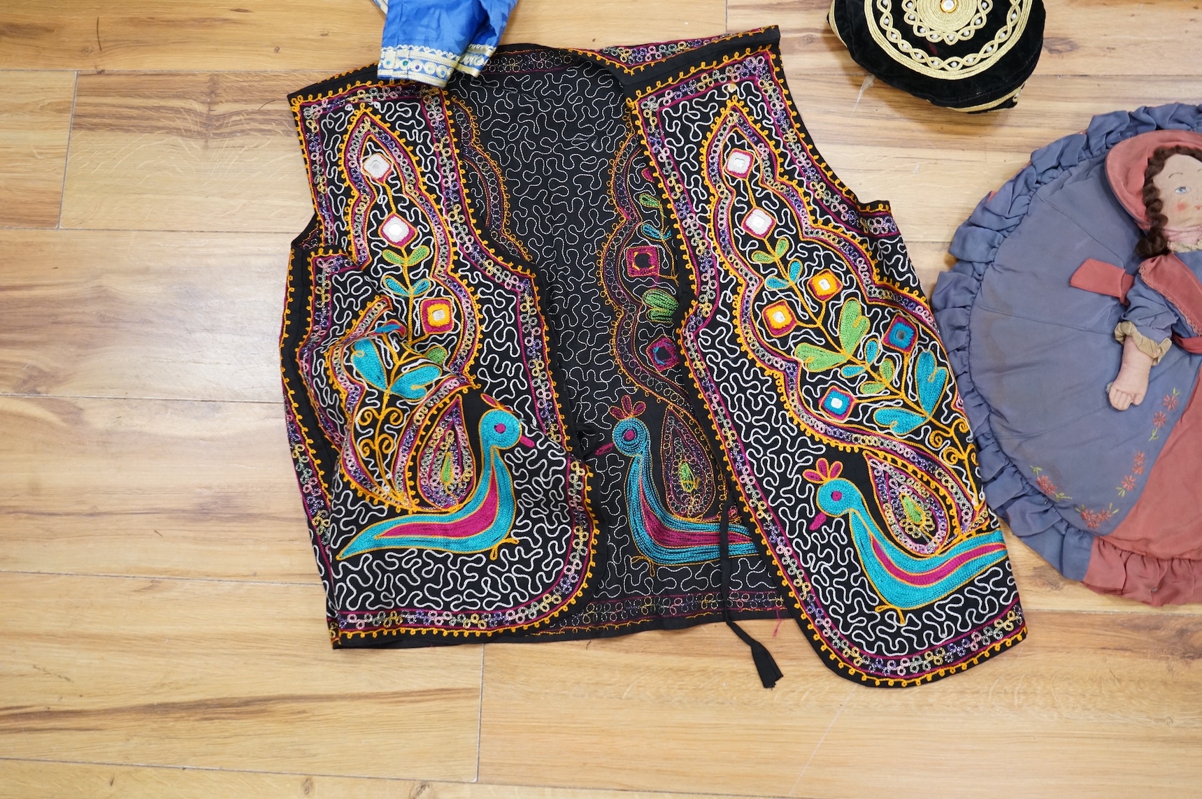 A quantity of mostly 20th century Middle Eastern and Indian woven and printed textiles and a peacock feather fan (2 boxes).